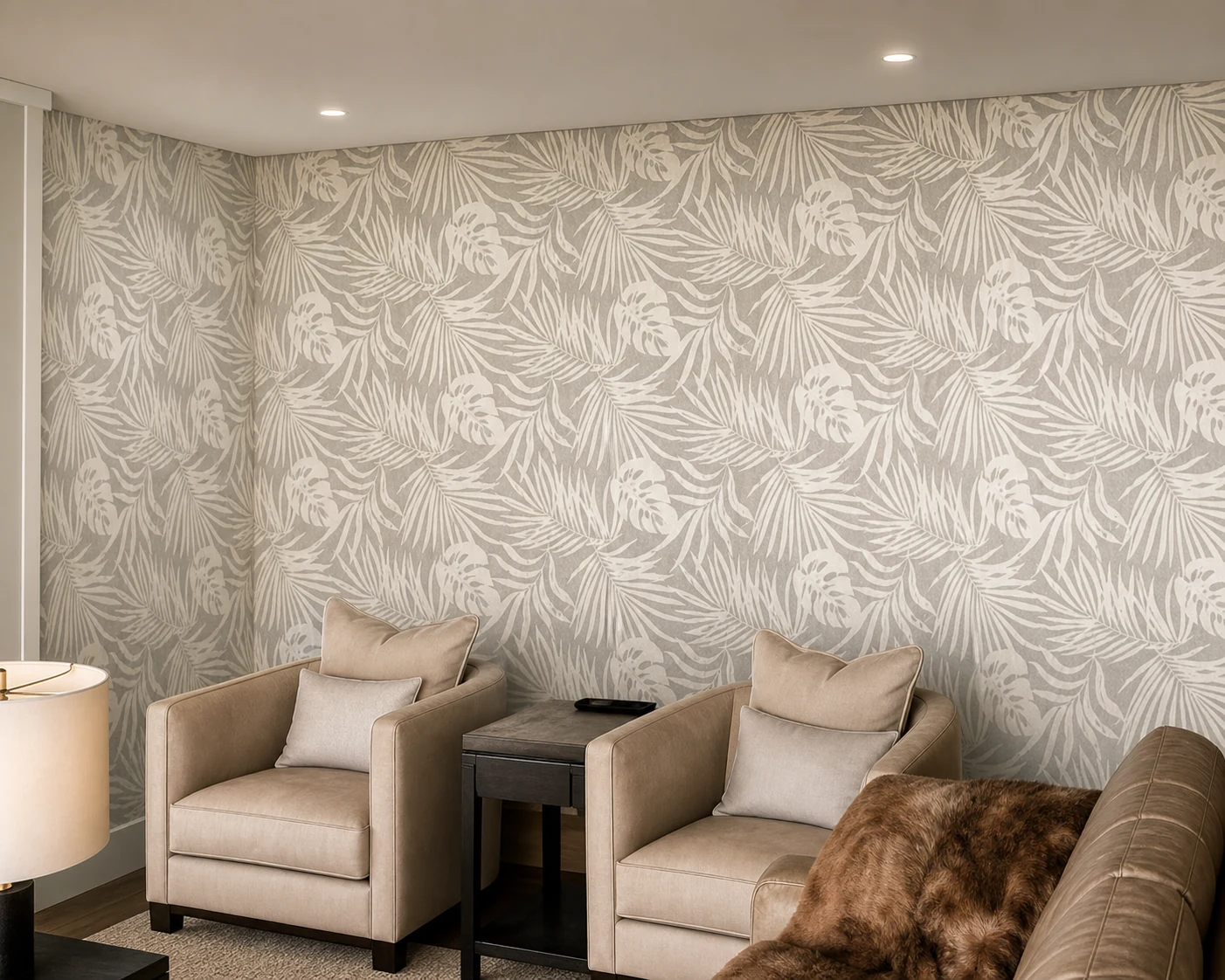 Palm leaf patterned wallpaper installed across a living room feature wall